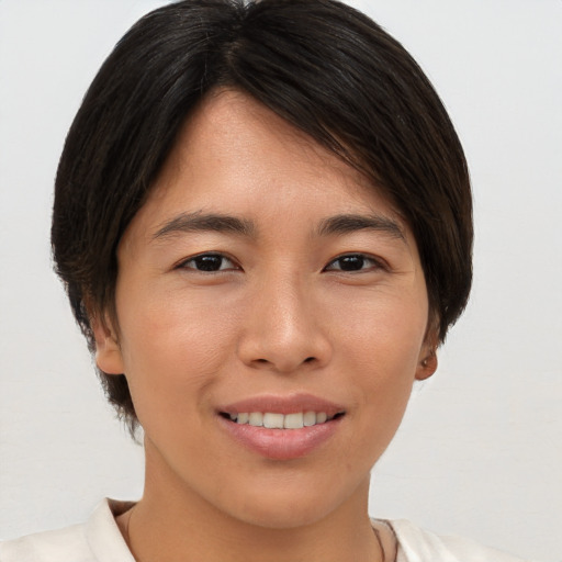 Joyful asian young-adult female with short  brown hair and brown eyes