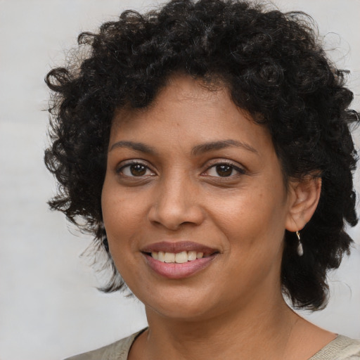 Joyful black young-adult female with medium  brown hair and brown eyes