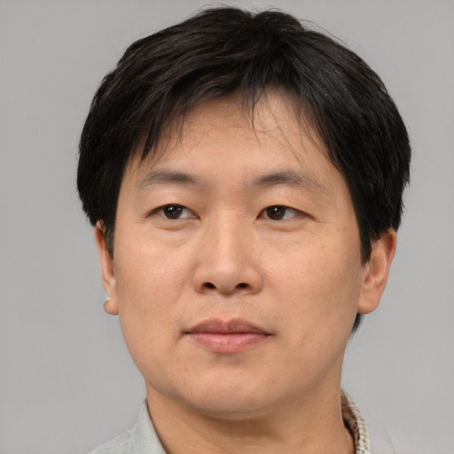Neutral asian adult male with short  brown hair and brown eyes