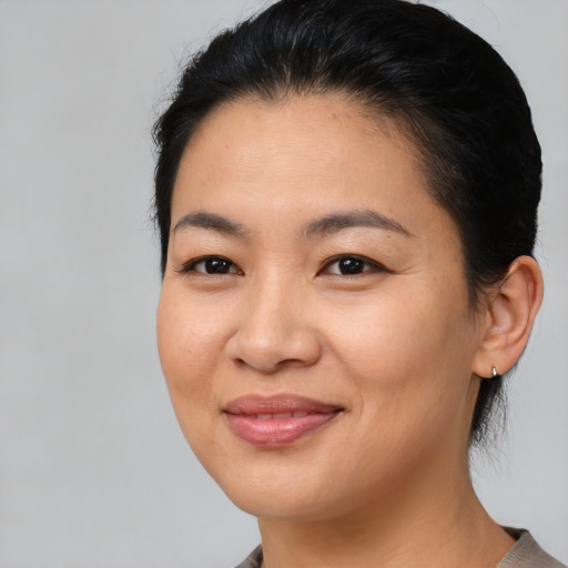 Joyful asian young-adult female with medium  brown hair and brown eyes