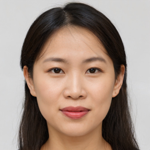Joyful asian young-adult female with long  brown hair and brown eyes