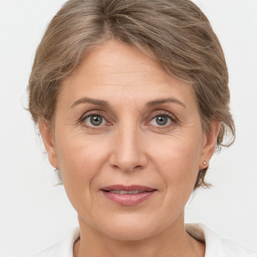 Joyful white adult female with short  brown hair and grey eyes