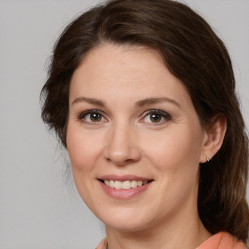 Joyful white young-adult female with medium  brown hair and brown eyes