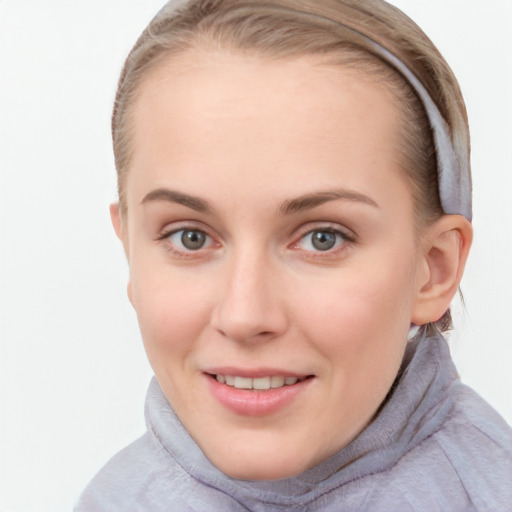 Joyful white young-adult female with short  brown hair and blue eyes