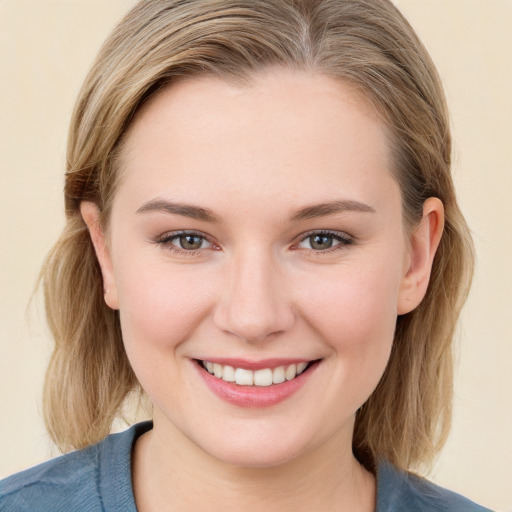 Joyful white young-adult female with medium  brown hair and blue eyes