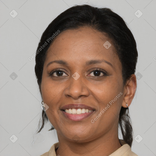 Joyful black adult female with medium  brown hair and brown eyes