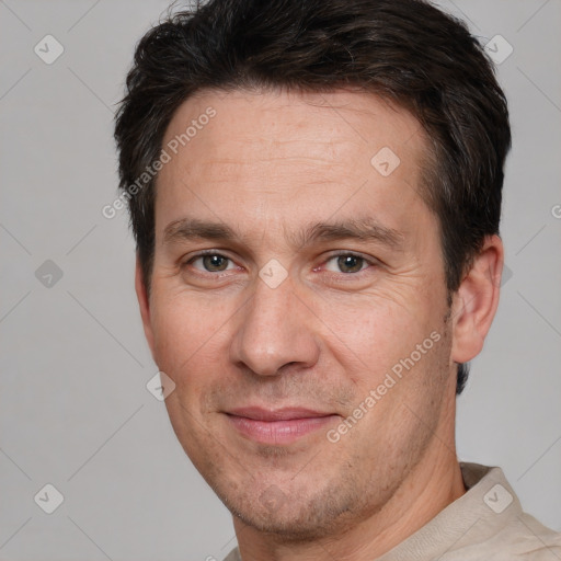 Joyful white adult male with short  brown hair and brown eyes