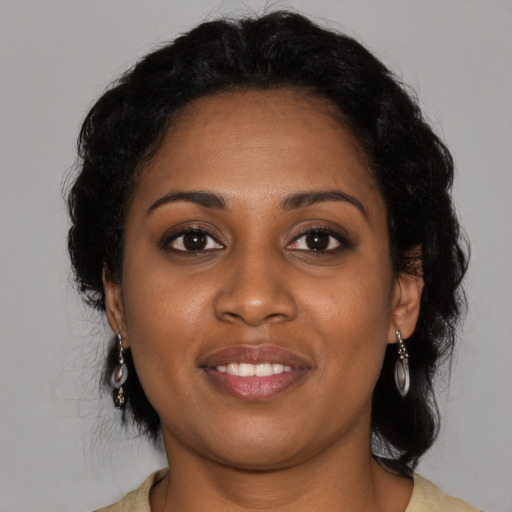 Joyful black young-adult female with medium  black hair and brown eyes
