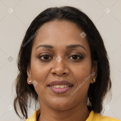 Joyful black adult female with medium  brown hair and brown eyes