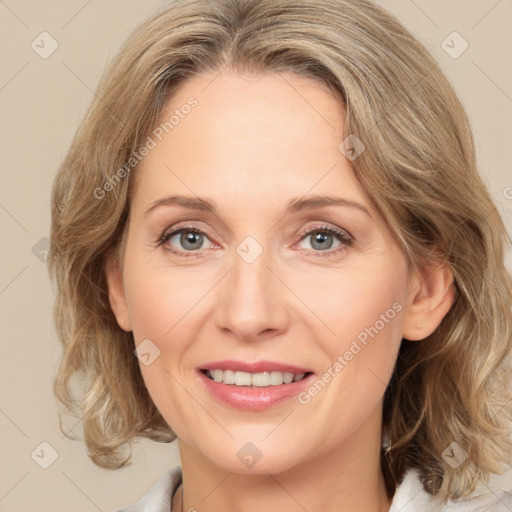 Joyful white adult female with medium  brown hair and green eyes