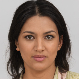 Joyful latino young-adult female with medium  brown hair and brown eyes