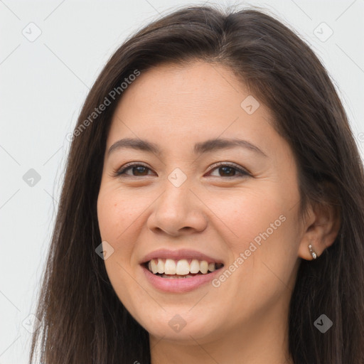 Joyful white young-adult female with long  brown hair and brown eyes