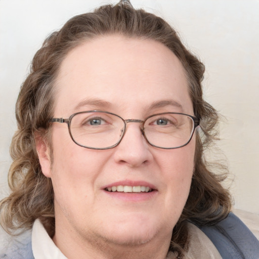 Joyful white adult female with medium  brown hair and blue eyes