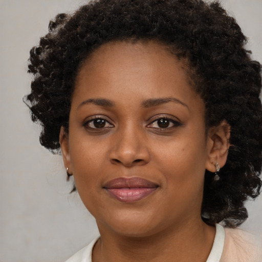 Joyful black young-adult female with medium  brown hair and brown eyes