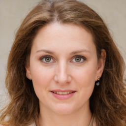 Joyful white young-adult female with long  brown hair and green eyes