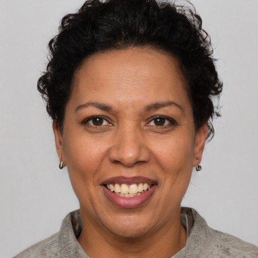 Joyful latino adult female with short  brown hair and brown eyes