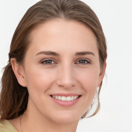 Joyful white young-adult female with medium  brown hair and grey eyes