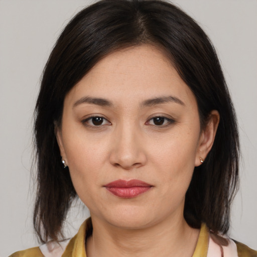 Joyful asian young-adult female with medium  brown hair and brown eyes