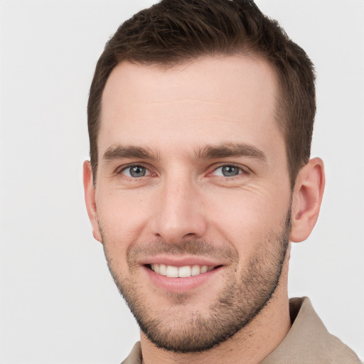 Joyful white young-adult male with short  brown hair and grey eyes