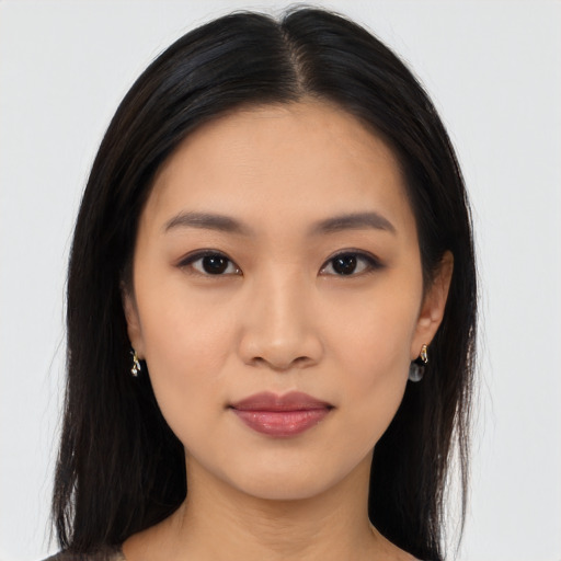 Joyful asian young-adult female with long  black hair and brown eyes