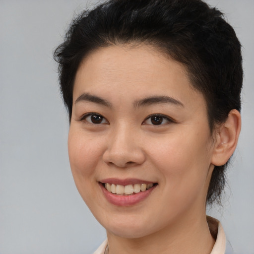 Joyful latino young-adult female with short  brown hair and brown eyes