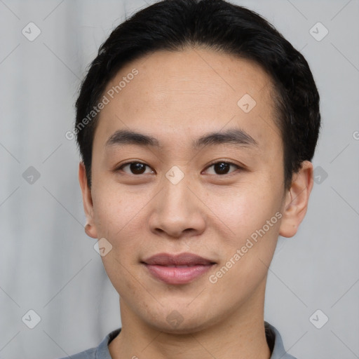 Joyful asian young-adult male with short  black hair and brown eyes