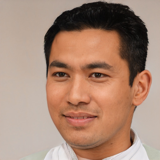 Joyful asian young-adult male with short  black hair and brown eyes