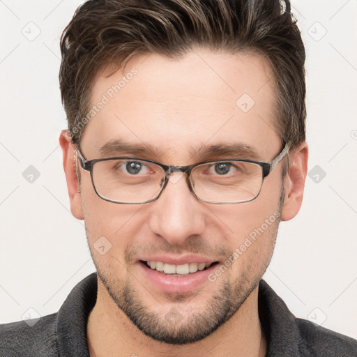 Joyful white adult male with short  brown hair and grey eyes