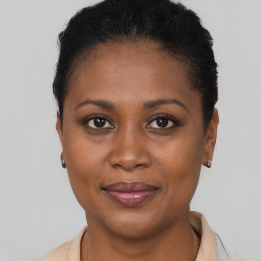 Joyful black young-adult female with short  brown hair and brown eyes