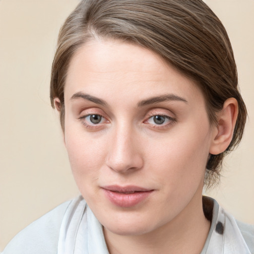 Joyful white young-adult female with medium  brown hair and blue eyes