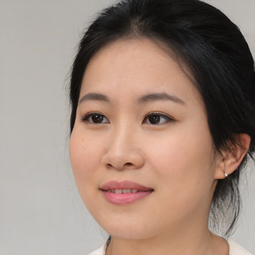 Joyful asian young-adult female with medium  brown hair and brown eyes