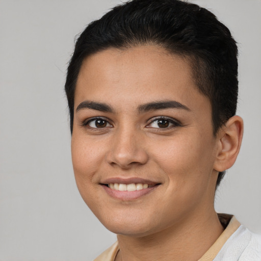 Joyful latino young-adult female with short  brown hair and brown eyes