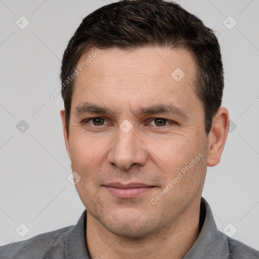 Joyful white adult male with short  brown hair and brown eyes