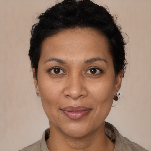 Joyful latino adult female with short  brown hair and brown eyes