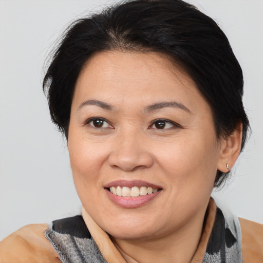 Joyful asian adult female with medium  brown hair and brown eyes