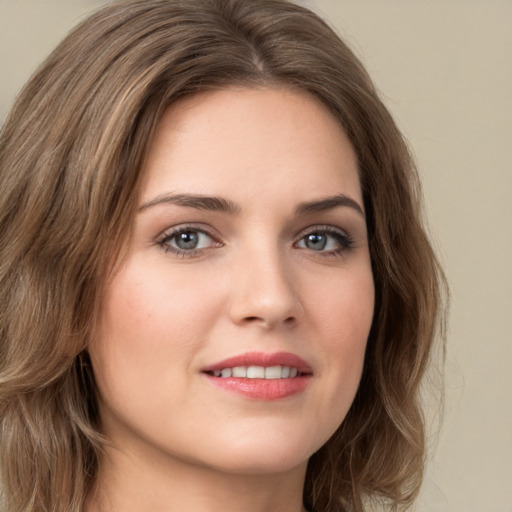 Joyful white young-adult female with long  brown hair and green eyes