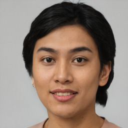 Joyful asian young-adult female with short  black hair and brown eyes