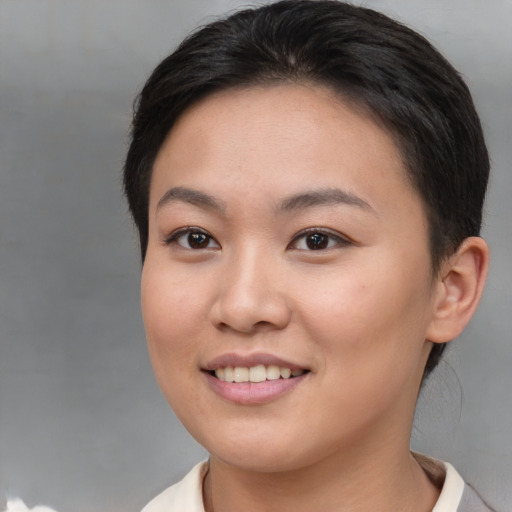 Joyful asian young-adult female with short  brown hair and brown eyes