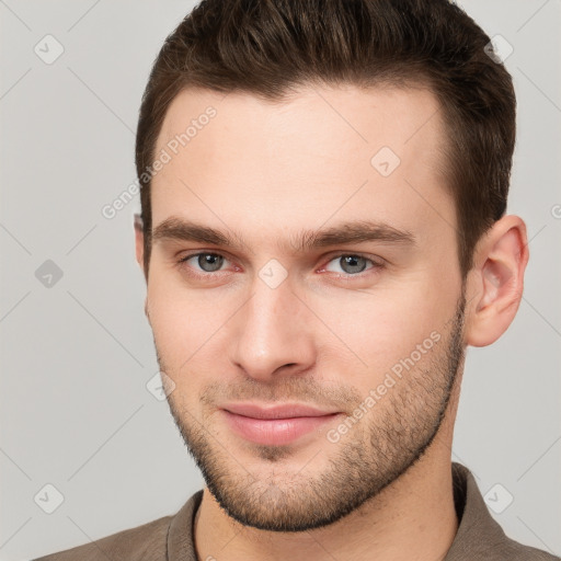 Joyful white young-adult male with short  brown hair and brown eyes