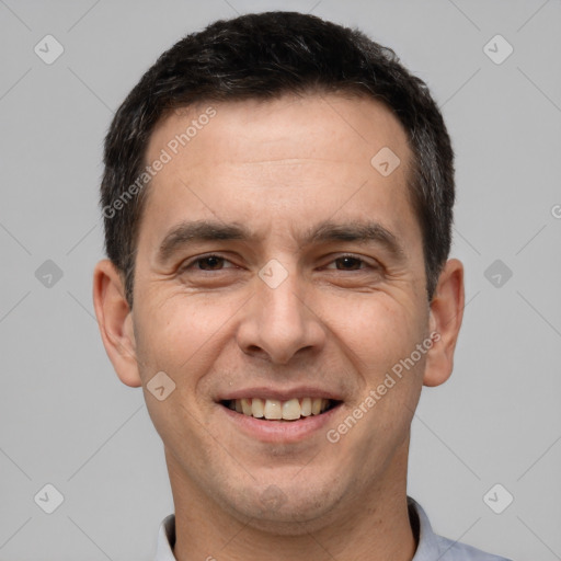 Joyful white adult male with short  brown hair and brown eyes