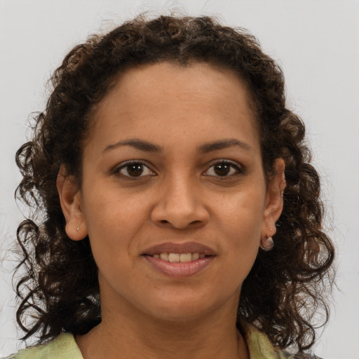 Joyful black young-adult female with medium  brown hair and brown eyes