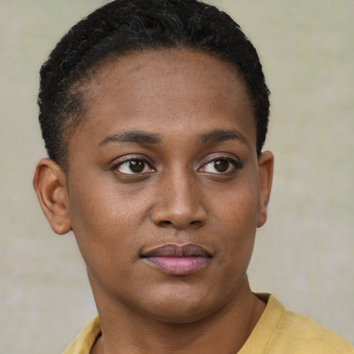 Joyful black young-adult female with short  brown hair and brown eyes
