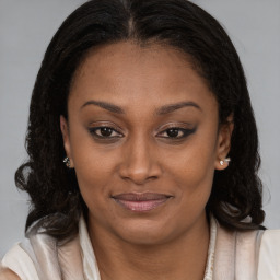 Joyful black young-adult female with medium  brown hair and brown eyes