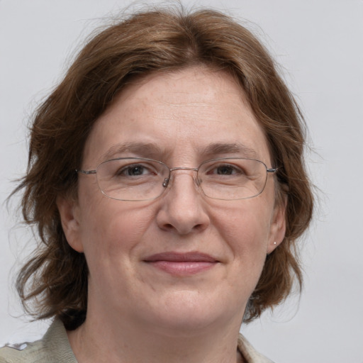 Joyful white adult female with medium  brown hair and grey eyes