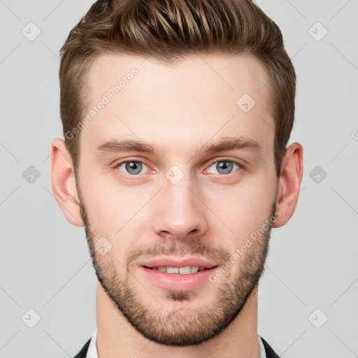 Joyful white young-adult male with short  brown hair and grey eyes