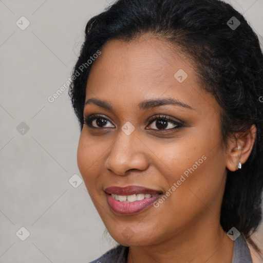 Joyful black young-adult female with long  brown hair and brown eyes