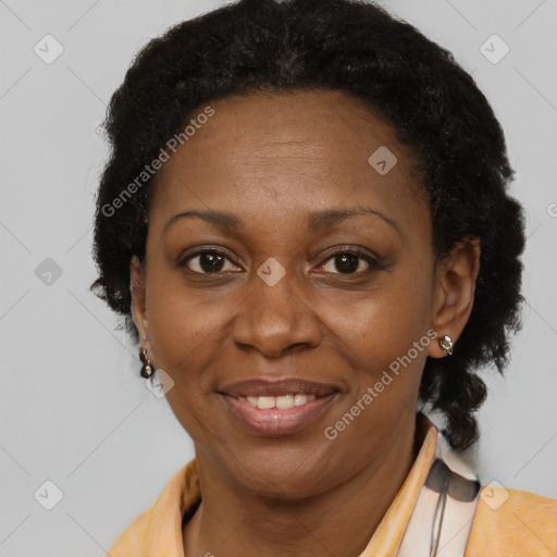 Joyful black adult female with short  brown hair and brown eyes