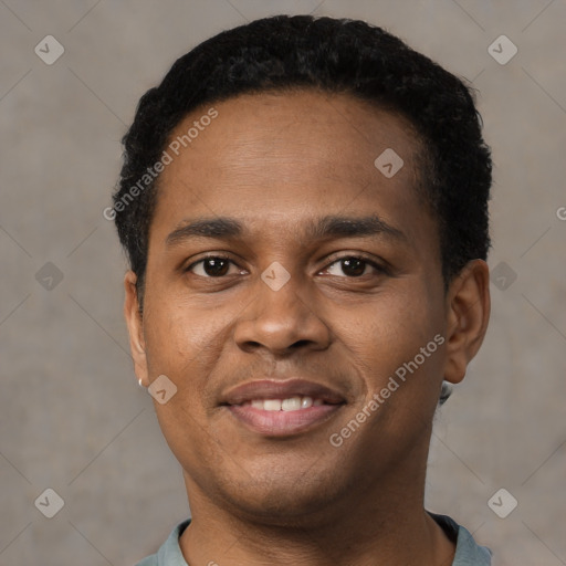 Joyful black young-adult male with short  black hair and brown eyes