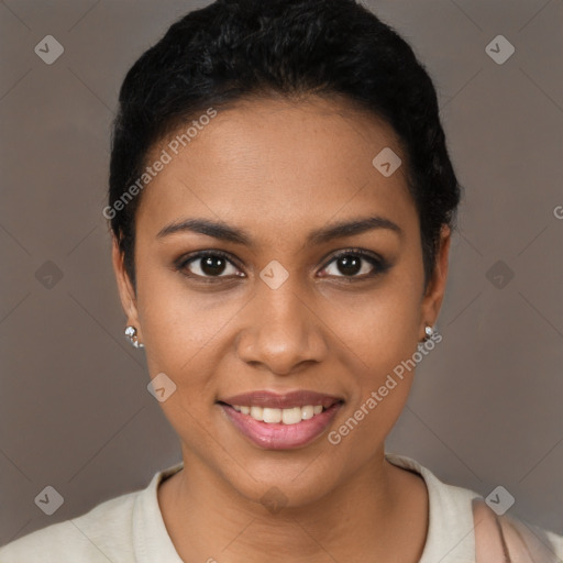 Joyful black young-adult female with short  black hair and brown eyes
