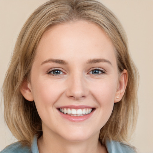 Joyful white young-adult female with medium  brown hair and blue eyes